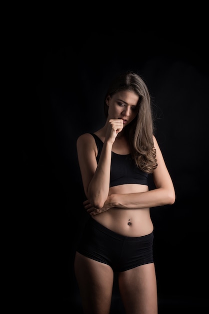 Beautiful woman with healthy body on black background