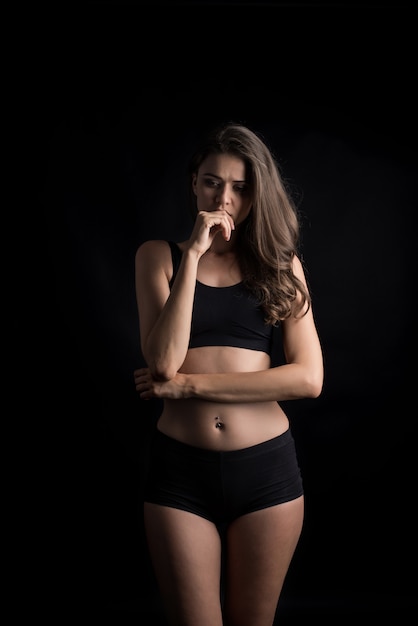 Beautiful woman with healthy body on black background