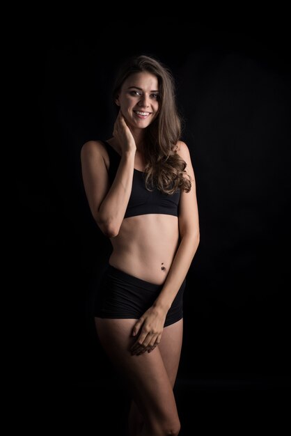 Beautiful woman with healthy body on black background