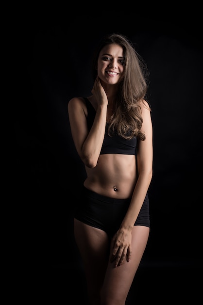 Beautiful woman with healthy body on black background