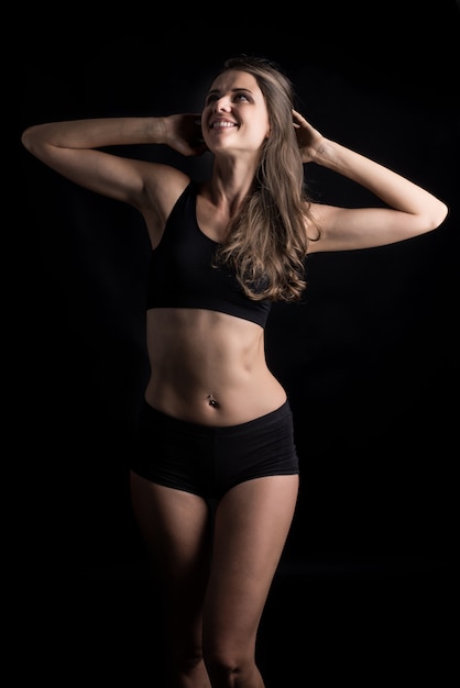 Free photo beautiful woman with healthy body on black background