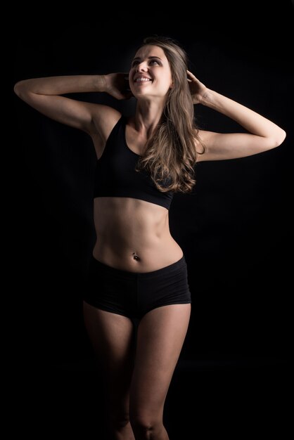 Beautiful woman with healthy body on black background