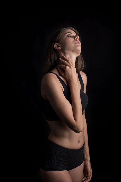 Beautiful woman with healthy body on black background