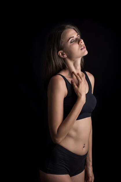 Beautiful woman with healthy body on black background