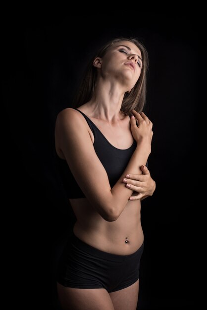 Beautiful woman with healthy body on black background