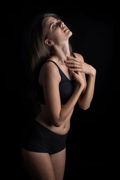 Beautiful woman with healthy body on black background