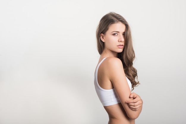 Beautiful woman with healthy body on white background