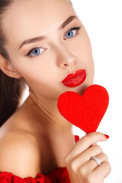 beautiful woman with a heart indoor isolated