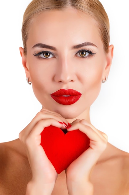 beautiful woman with a heart indoor isolated