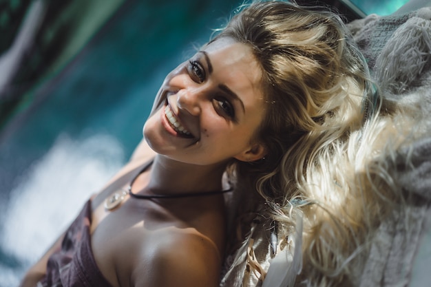 beautiful woman with long blond hair. happy face smiles.