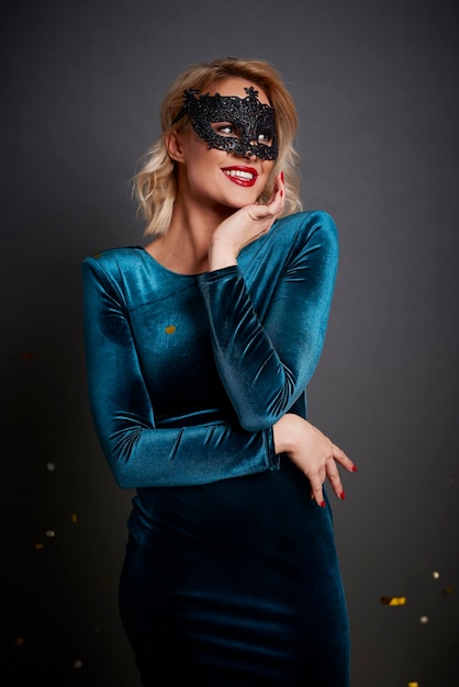 Free photo beautiful woman with masquerade mask looking at copy space