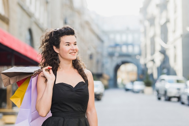 Beautiful woman with multi colored shopping bags