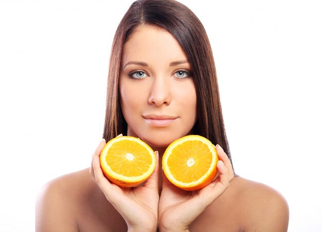Beautiful woman with orange in hands