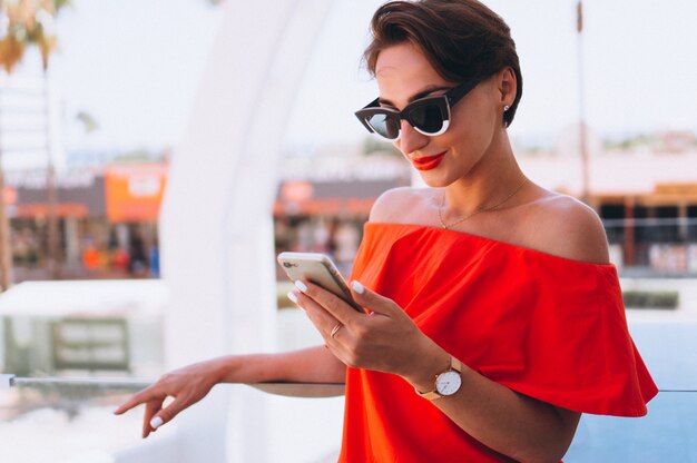 Beautiful woman with phone on a vacation