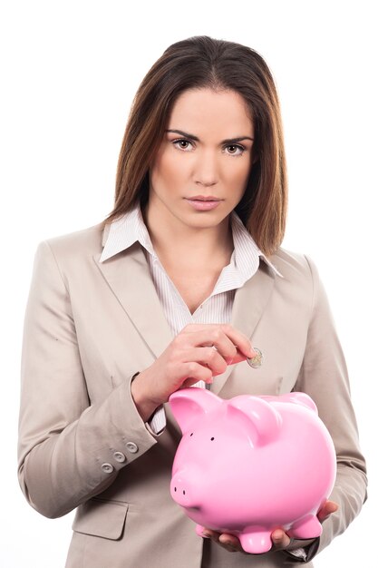 Beautiful woman with piggy bank and coin
