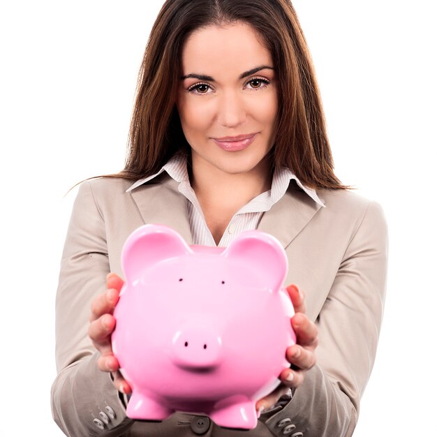 Beautiful woman with piggy bank on white background