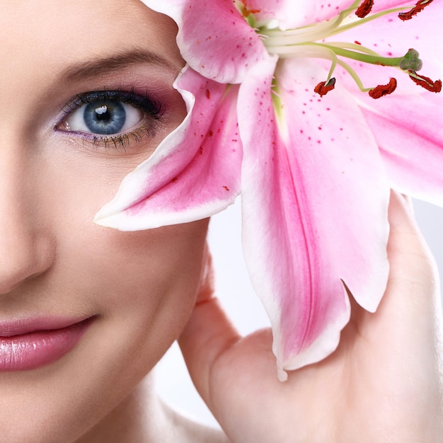 Beautiful woman with pink lily flower