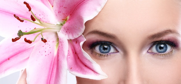 Beautiful woman with pink lily flower