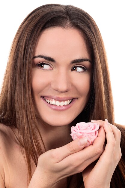 Beautiful woman with pink rose on white background