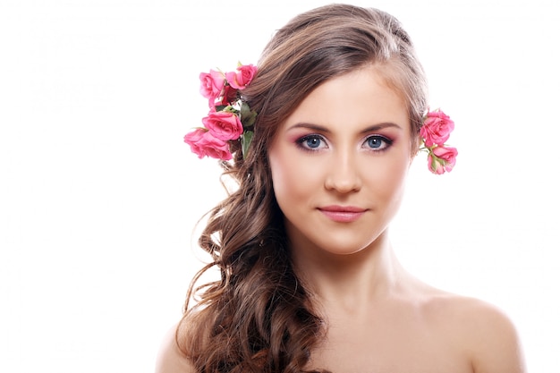 Beautiful woman with roses in hair