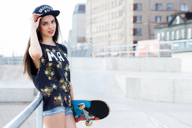 Free photo beautiful woman with skateboard