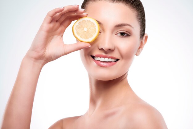 Beautiful woman with slice of lemon