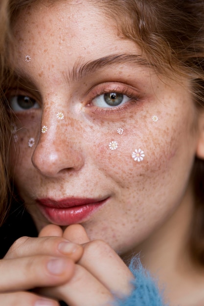 Beautiful woman with white flowers on her face