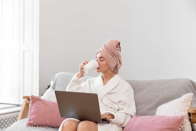 Beautiful woman working after taking a bath