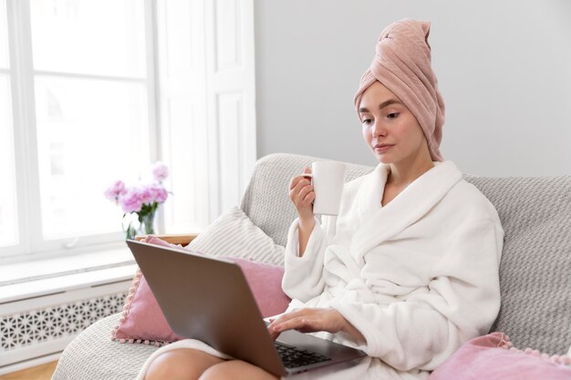 Beautiful woman working after taking a bath