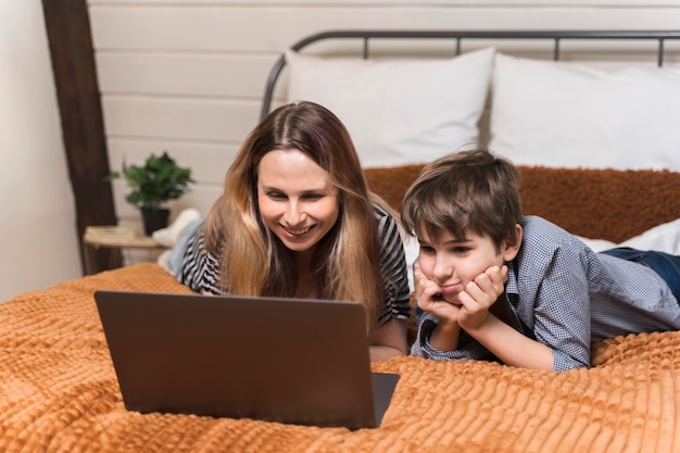 Beautiful woman working from home with her son