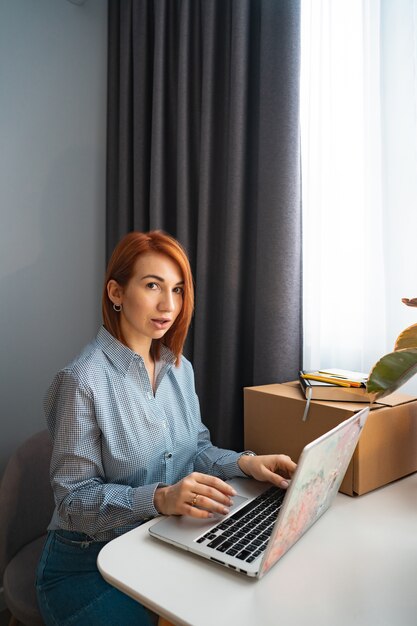 Beautiful woman working on laptop in co-working area