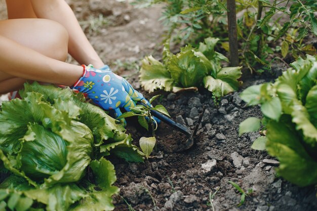 Beautiful woman works in a garden 