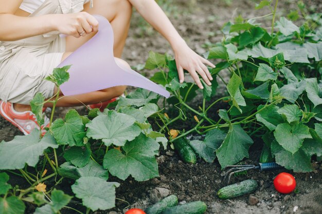 Beautiful woman works in a garden 