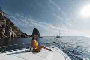 Free photo beautiful woman on yacht in swimwear