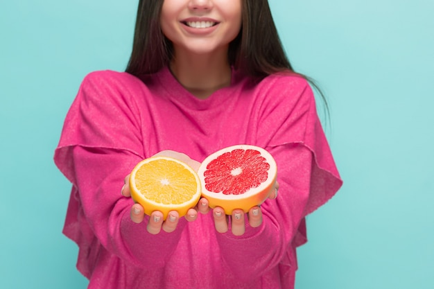 Free photo beautiful womans face with juicy orange