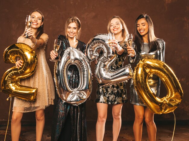 Beautiful Women Celebrating New Year.Happy Gorgeous Girls In Stylish Sexy Party Dresses