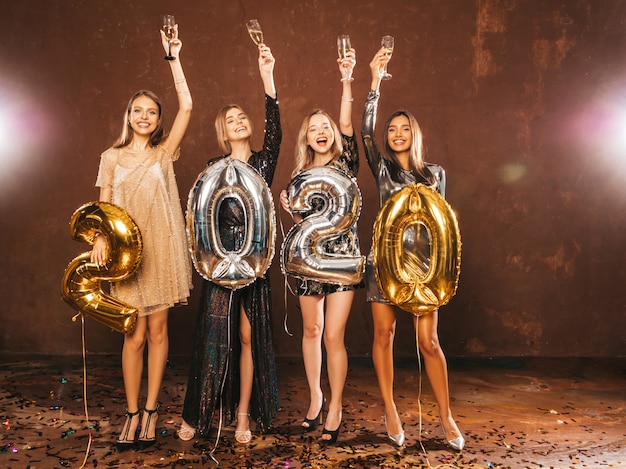 Beautiful Women Celebrating New Year.Happy Gorgeous Girls In Stylish Sexy Party Dresses