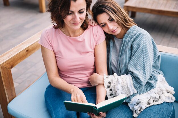 Beautiful women reading book on couch