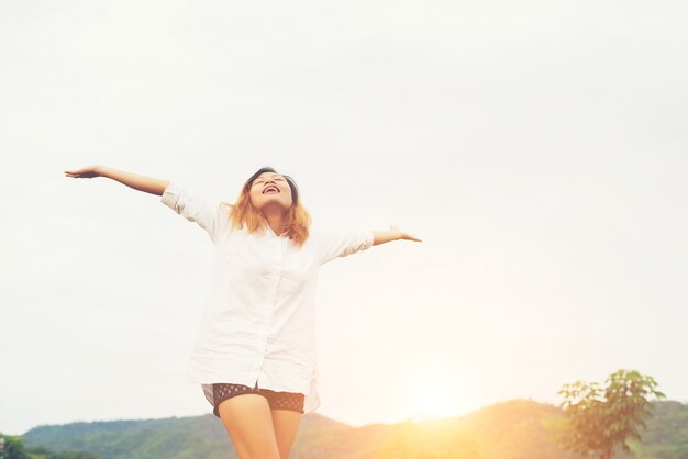 Beautiful women standing raising arm after waking, enjoy with fr