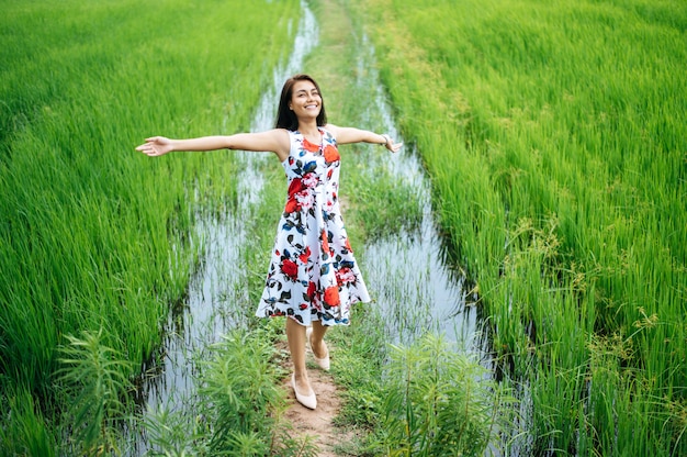 Beautiful women walk happily on the meadow