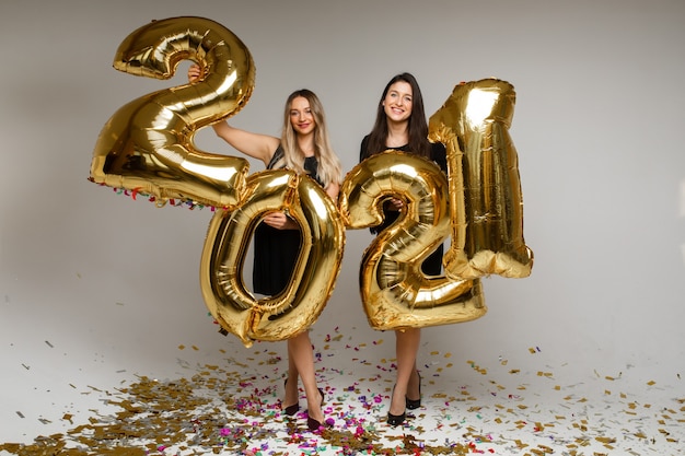 Beautiful women with New Year balloons 2021.