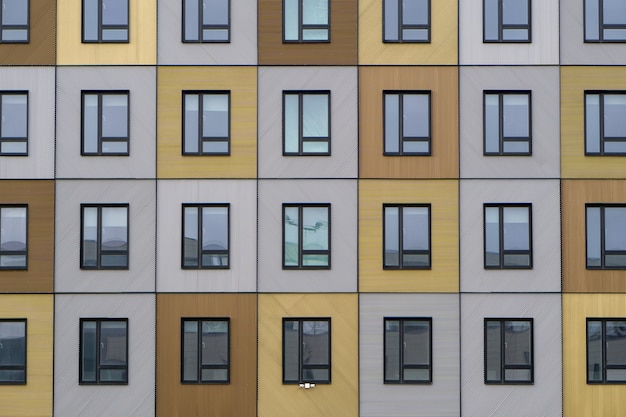 Beautiful wooden facade of a modern building reflecting the sky