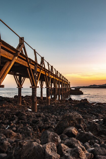Beautiful wooden pier at the coast of the sea with a beautiful sunset 