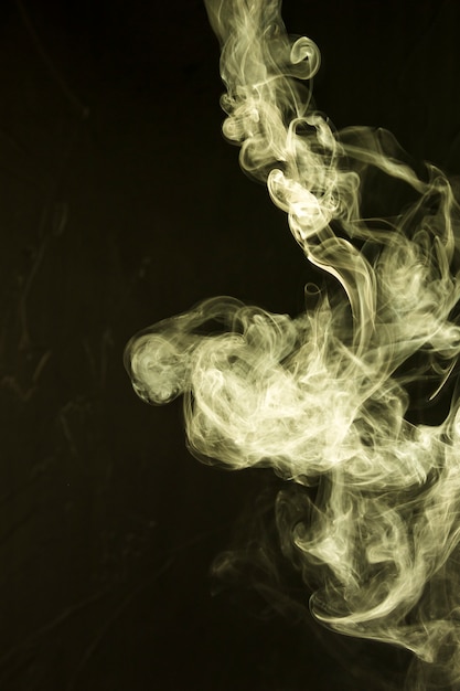 Beautiful yellow smoke abstract on black background