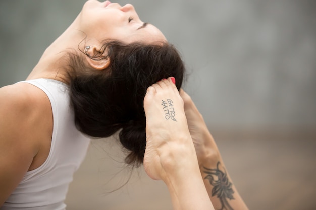 Free photo beautiful yoga: raja bhudjangasana pose