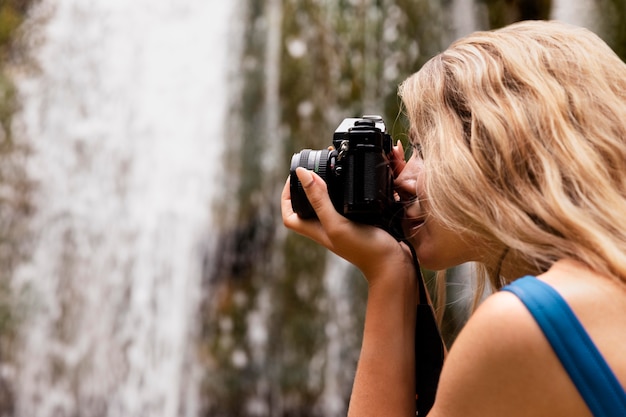 Beautiful young adult by the waterfall