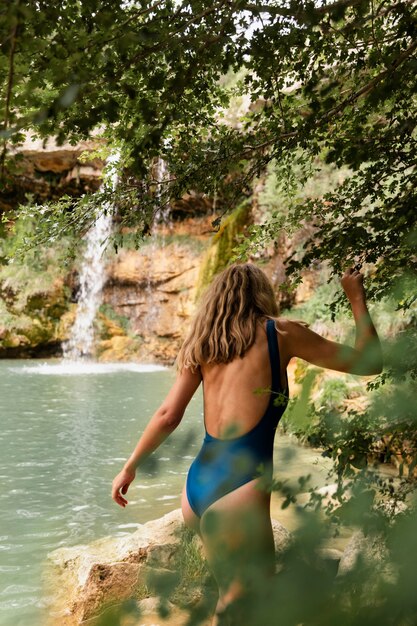 Beautiful young adult by the waterfall