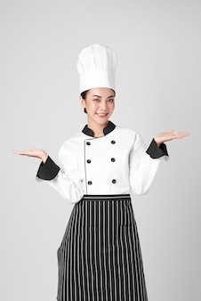 Beautiful young asian woman chef on white background,