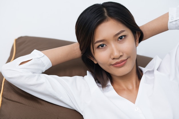 Beautiful Young Asian Woman Lying on Cushion