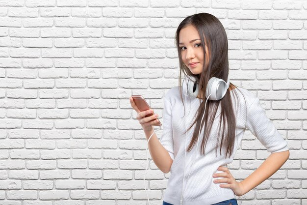 Beautiful young asian woman wearing a set of headphones